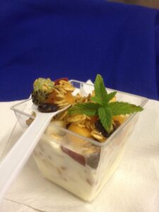 Granola and yoghurt pot with mint and serving spoon